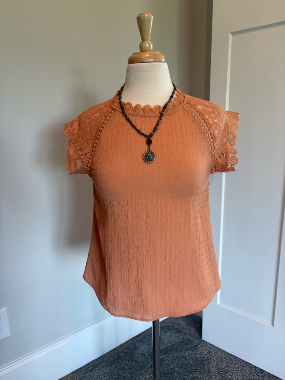 Women's Lace Sleeve/Neckline Textured Top. Light to Medium Peach Color.